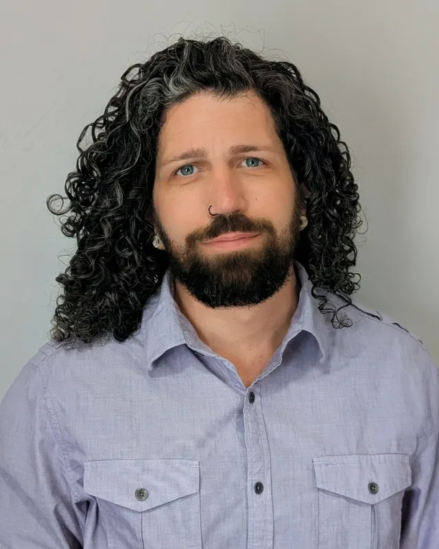 Simon Rook, founder of Vision to Story Design, in a lavender button-down shirt